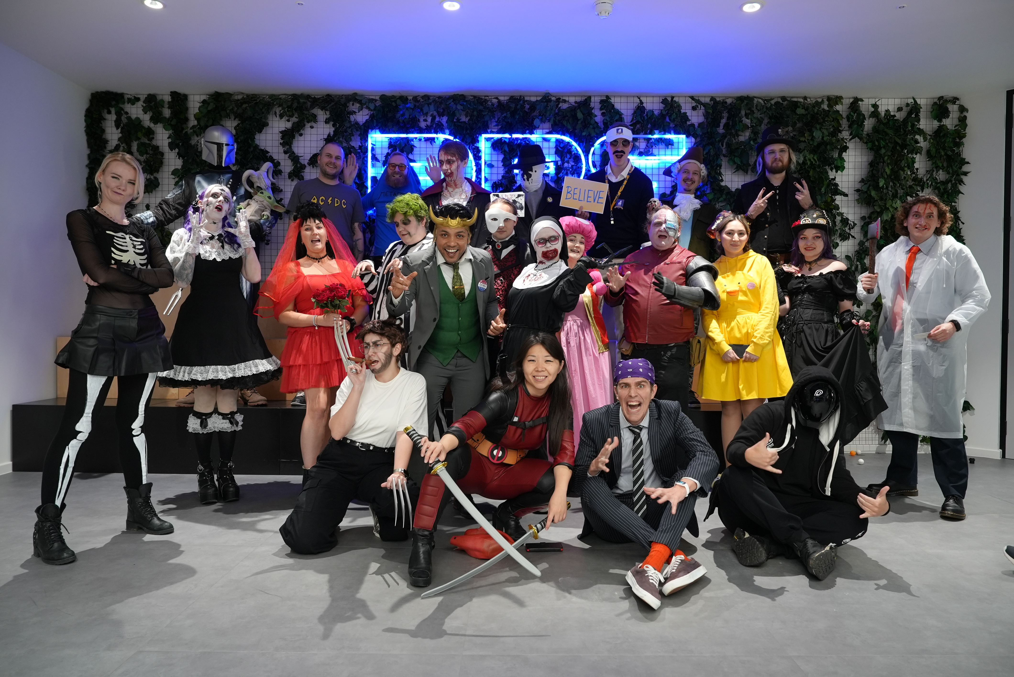 Team photo of a Halloween Party by the DPS sign